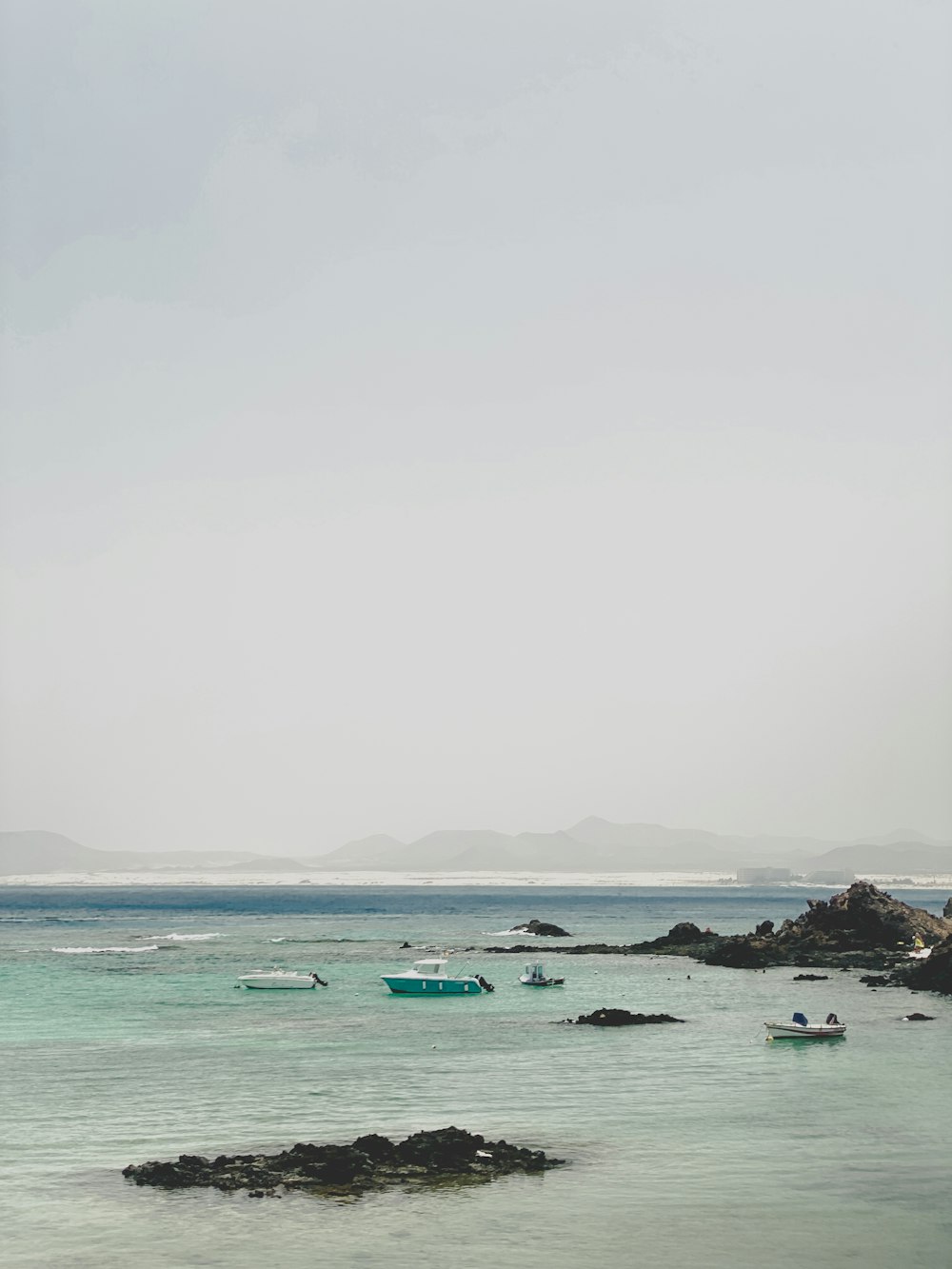 a group of boats floating on top of a body of water