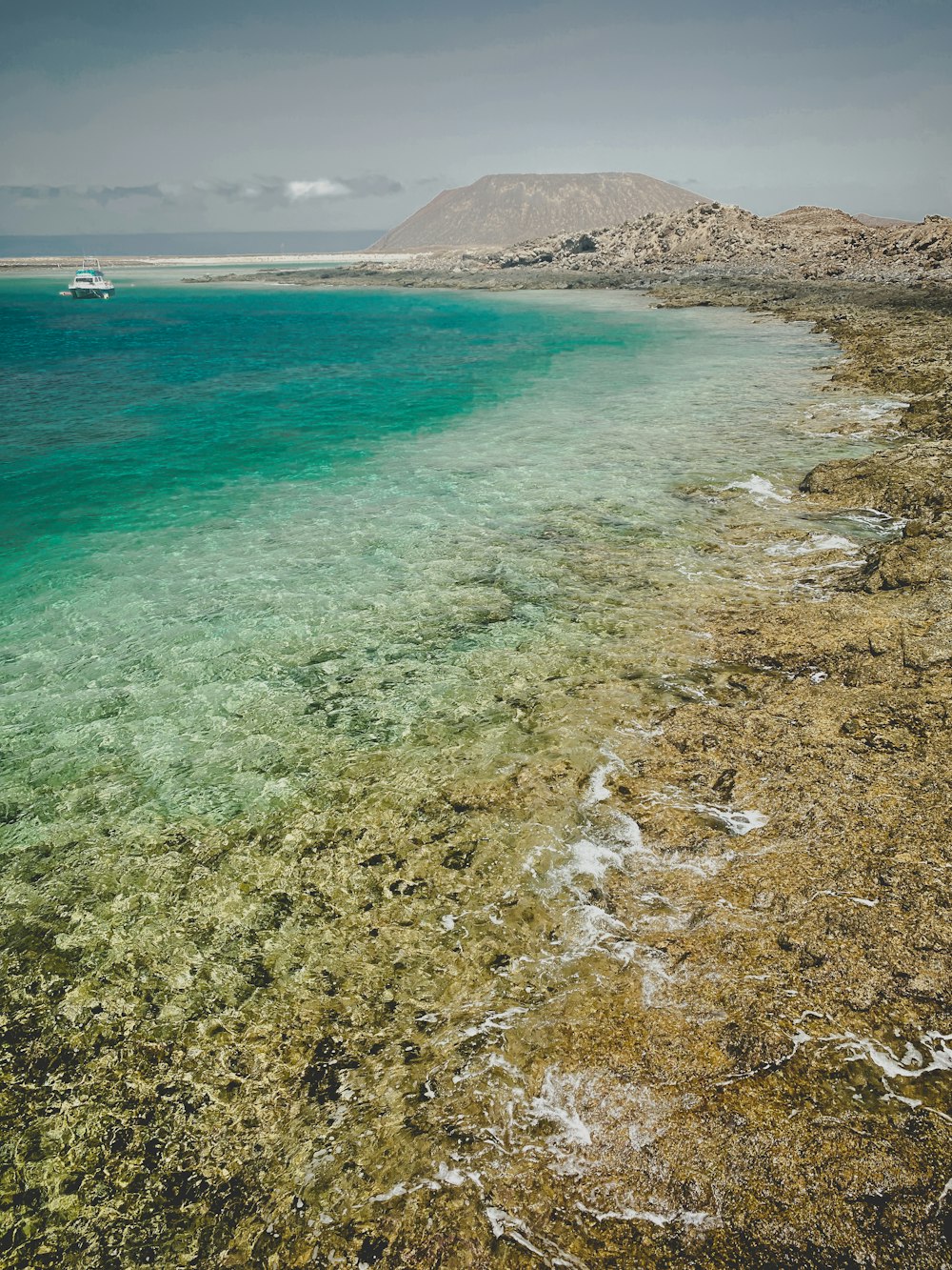 a body of water with a boat in the distance