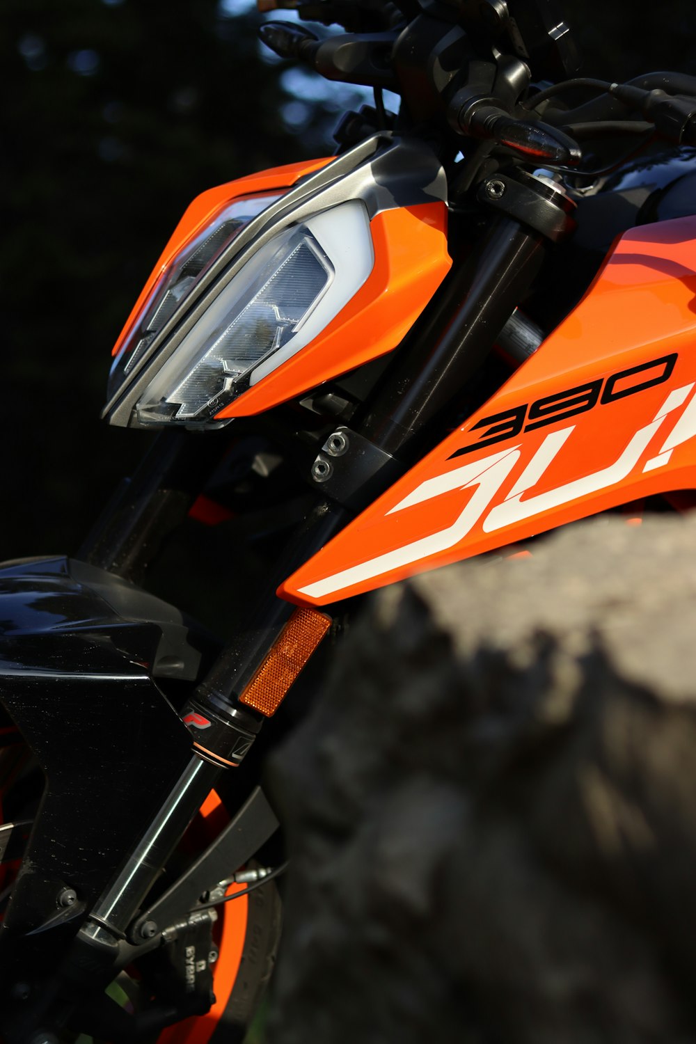 a close up of an orange and black motorcycle