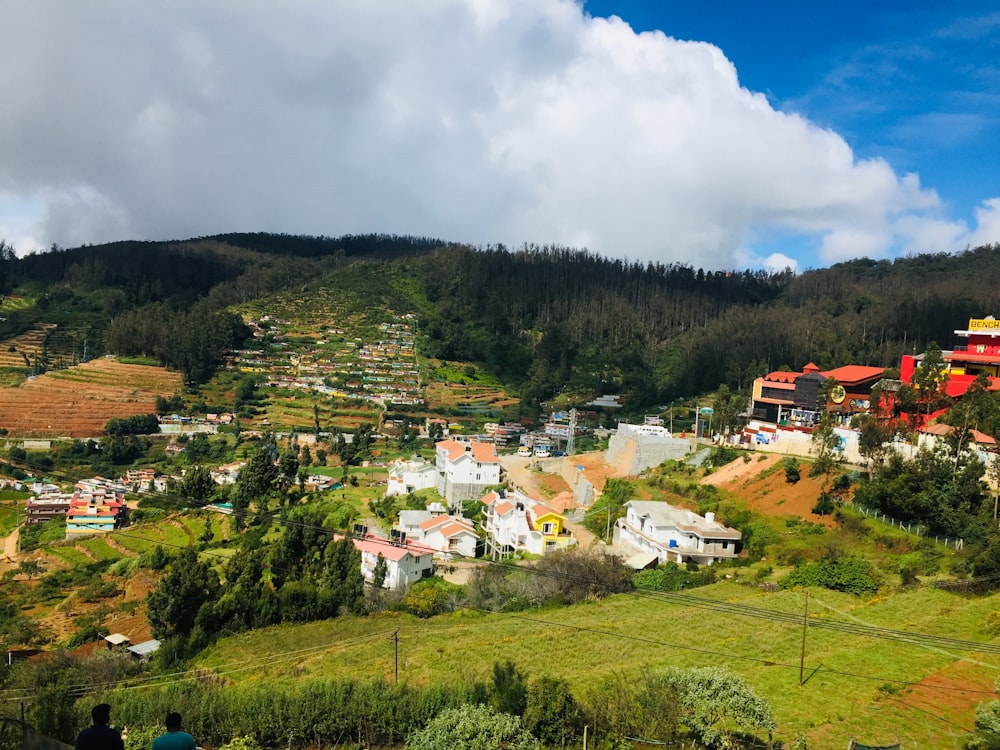 a scenic view of a village in the mountains