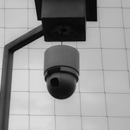 a black and white photo of a security camera