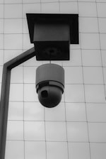 a black and white photo of a security camera