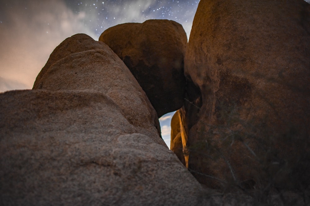 some rocks under a night sky filled with stars