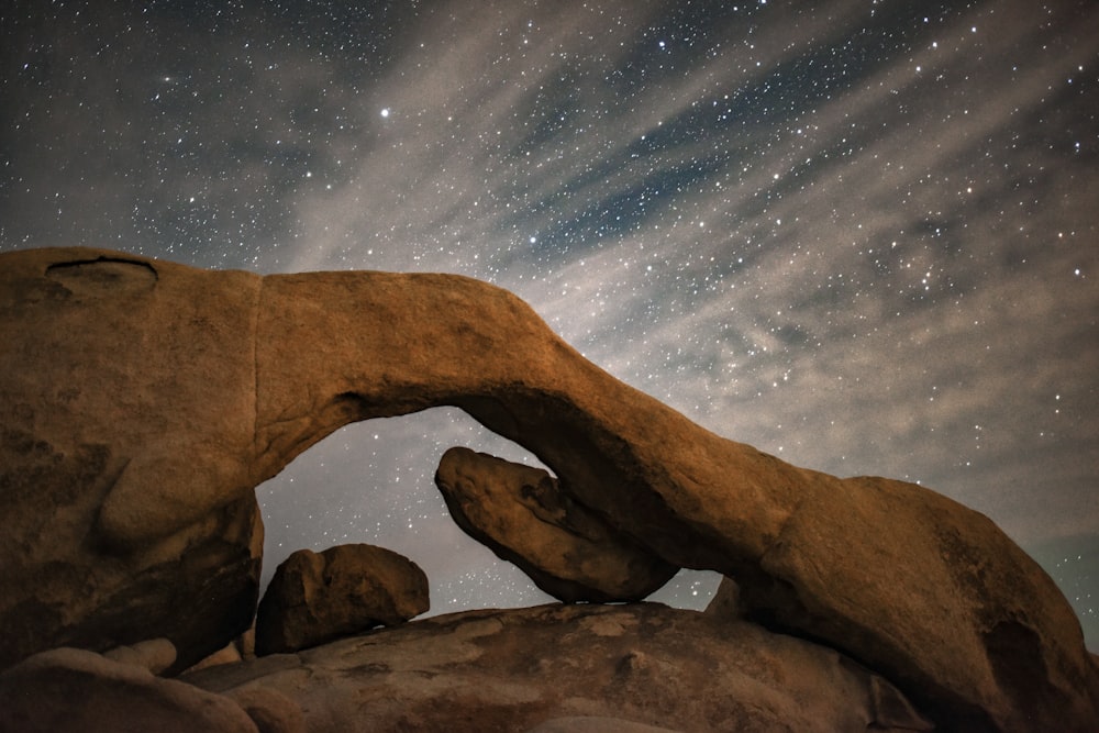 a rock formation with stars in the background