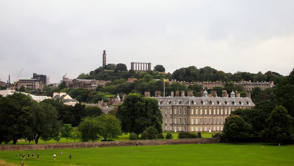 a large building with a hill in the background