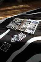 an open book laying on top of a zebra print blanket