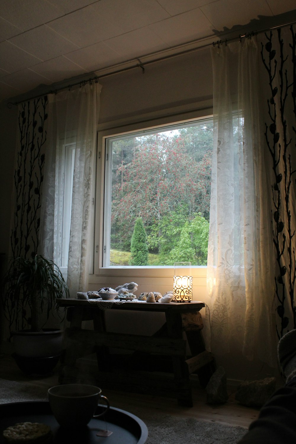 a living room with a table and a large window