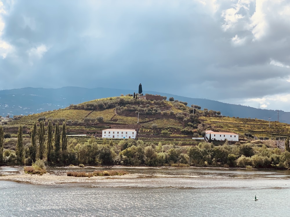 a house on a hill overlooking a body of water