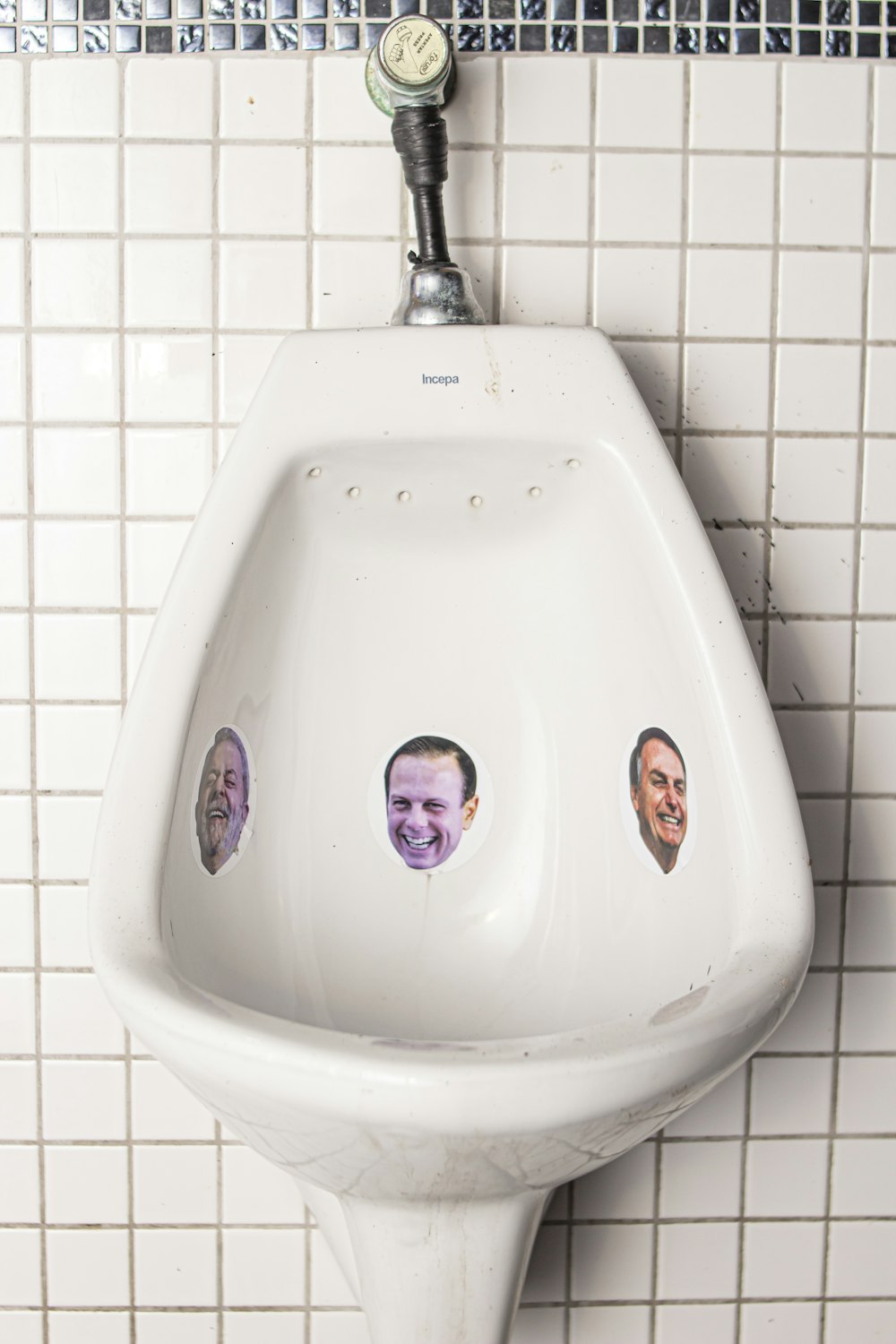 ein Urinal mit einem Haufen Aufkleber darauf