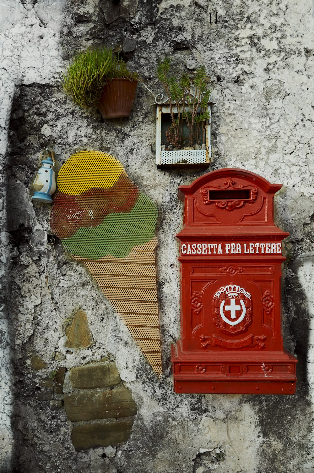 a red mailbox sitting on top of a stone wall