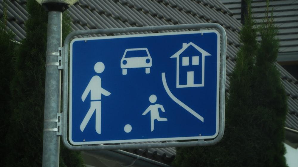 a blue sign with a picture of a person and a car