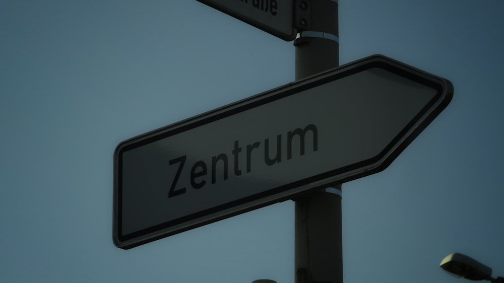 a close up of a street sign with a sky background