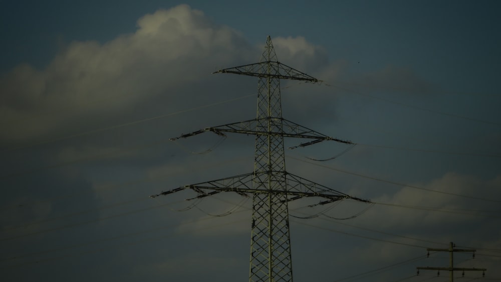 a high voltage power line against a cloudy sky