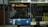A city bus displaying the destination 'KVG Braunschweig' on its digital front sign. The bus is mainly blue with white accents, and there is an advertisement on its side. It is parked in an urban setting, and a person is visible inside, possibly the driver.