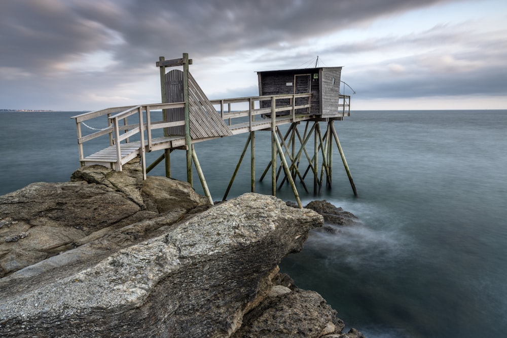 a wooden structure sitting on top of a rocky cliff