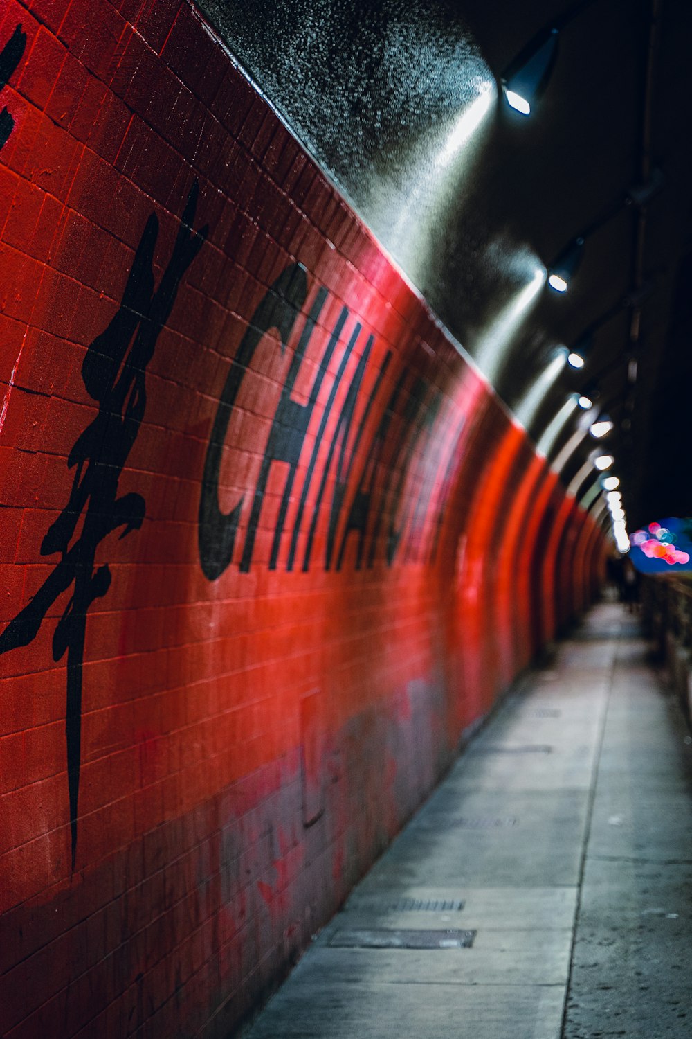 a long red wall with chinese writing on it