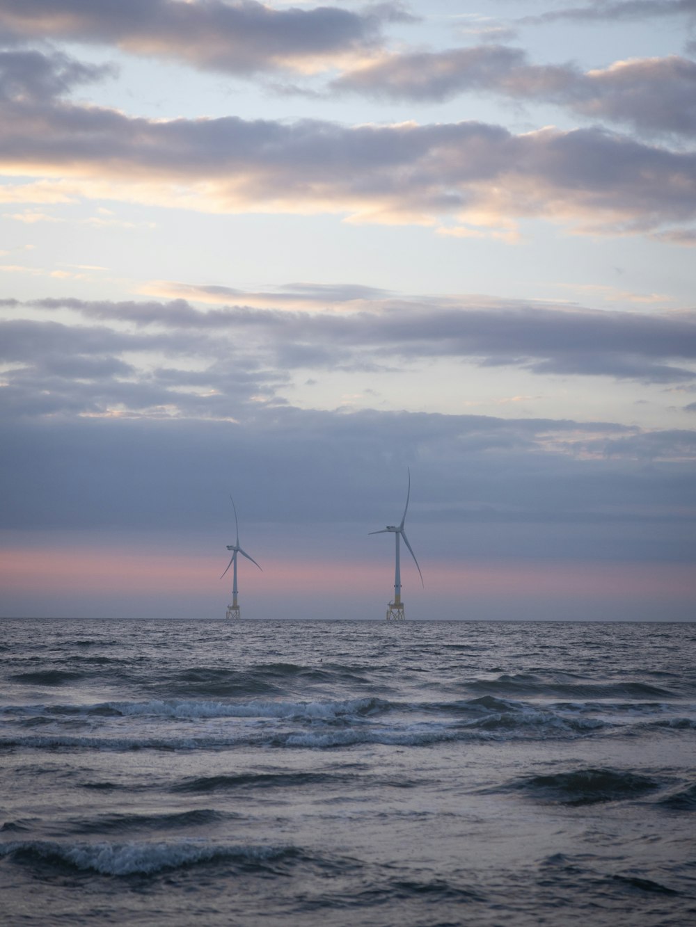 a couple of windmills that are in the water