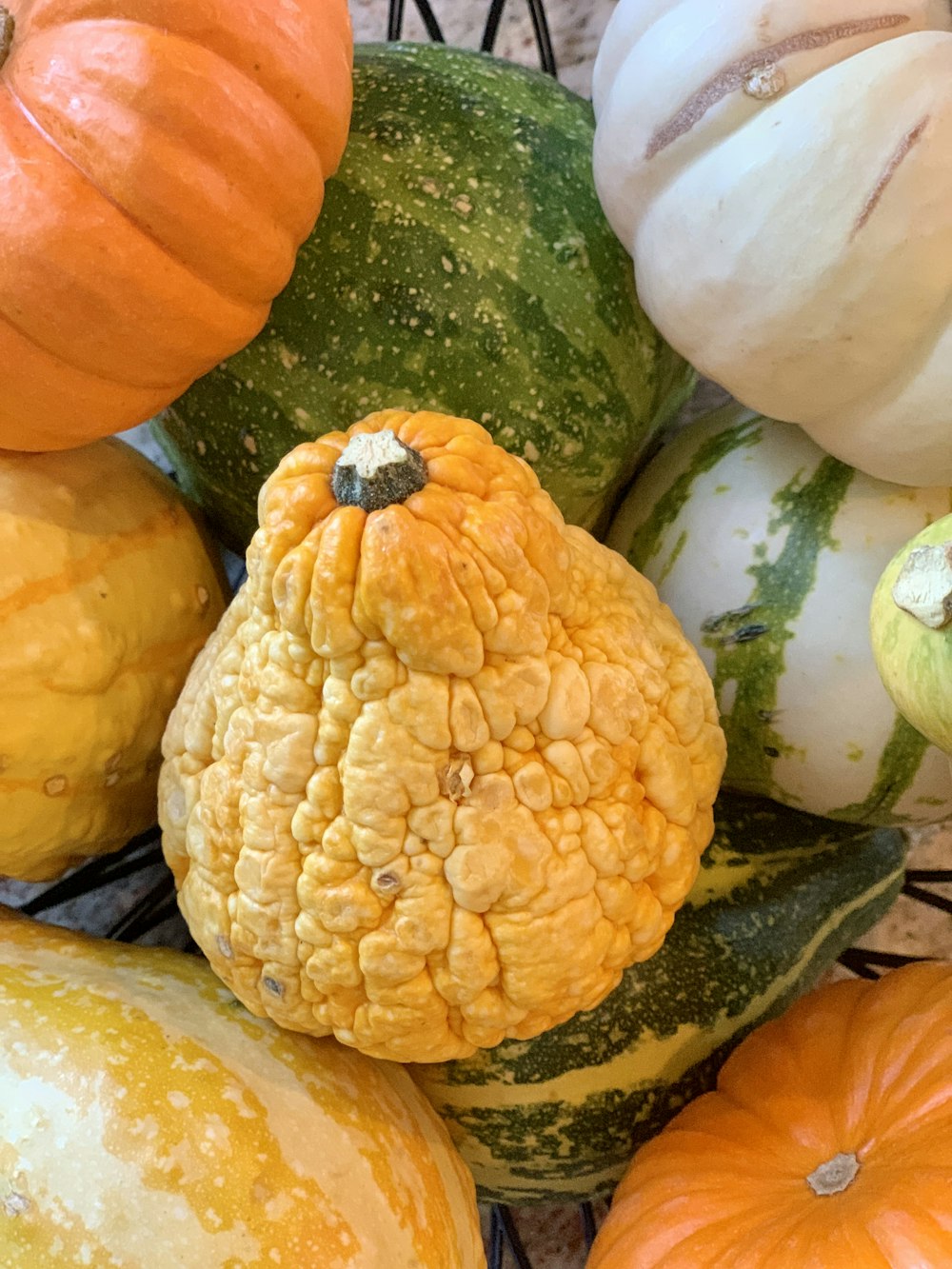 a bunch of pumpkins sitting on top of each other