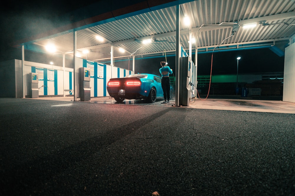 a car is parked at a gas station at night