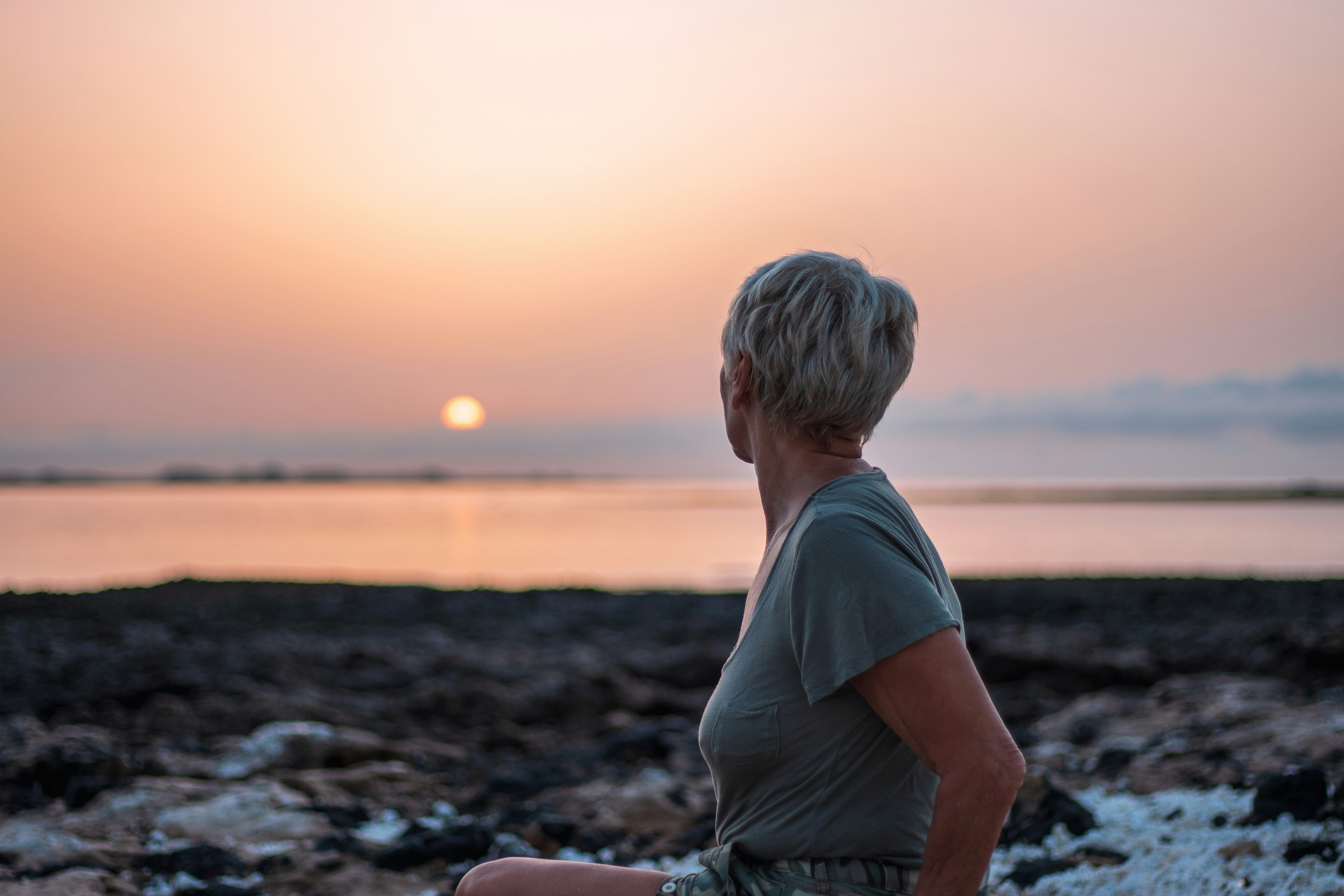 Woman on rock sunset