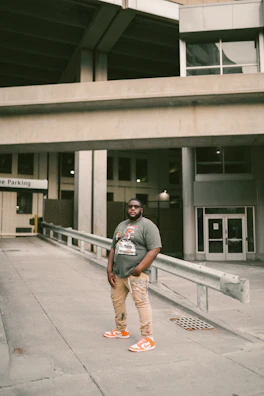 Model wearing a bright t-shirt with a bold graphic of Puerto Rican urban architecture.