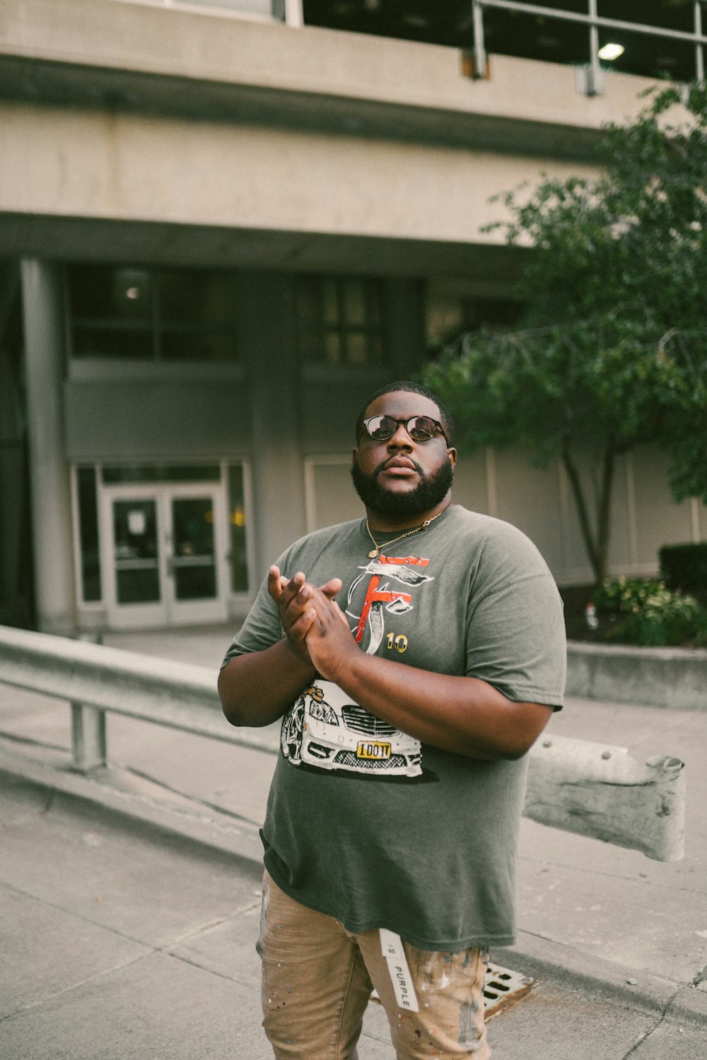 a man standing on a sidewalk in front of a building