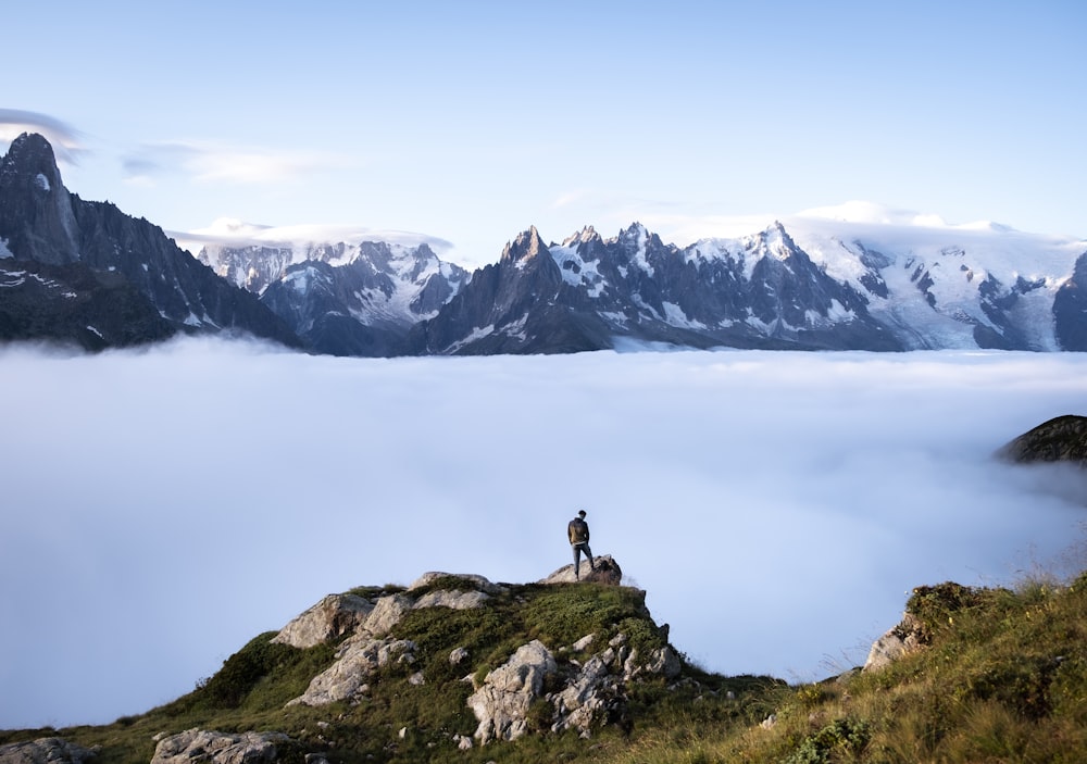 a couple of people standing on top of a mountain