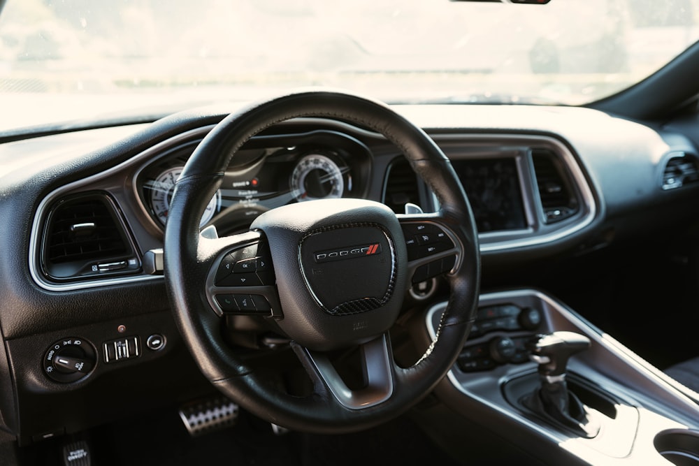 the interior of a car with a steering wheel and dashboard