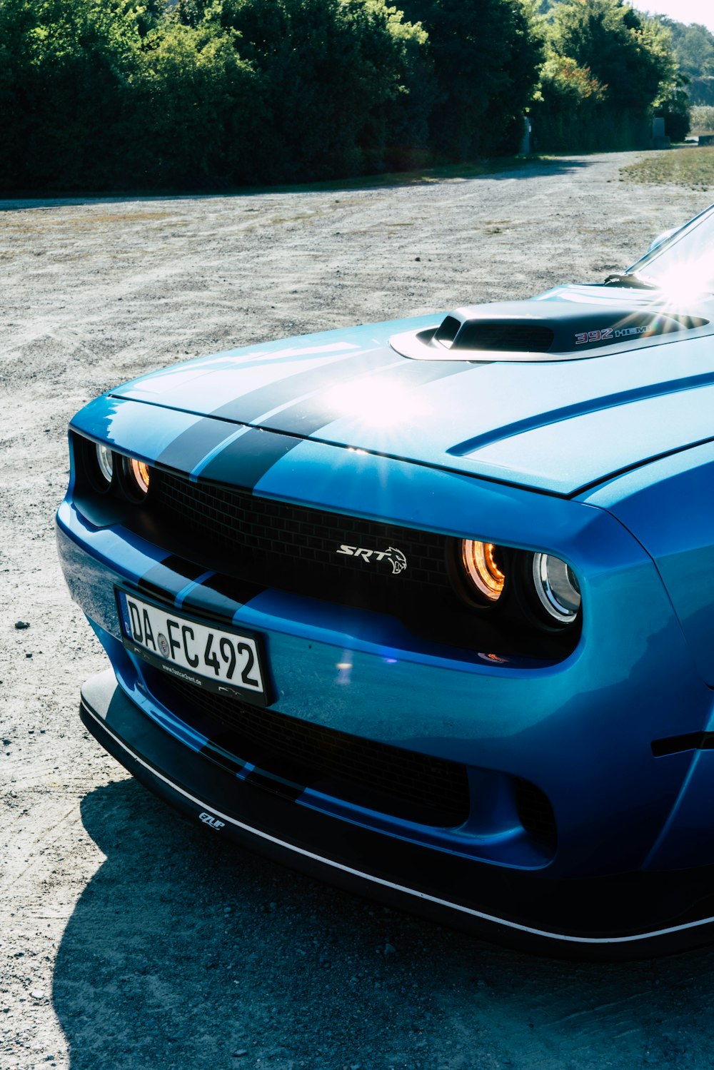 a blue sports car parked in a parking lot