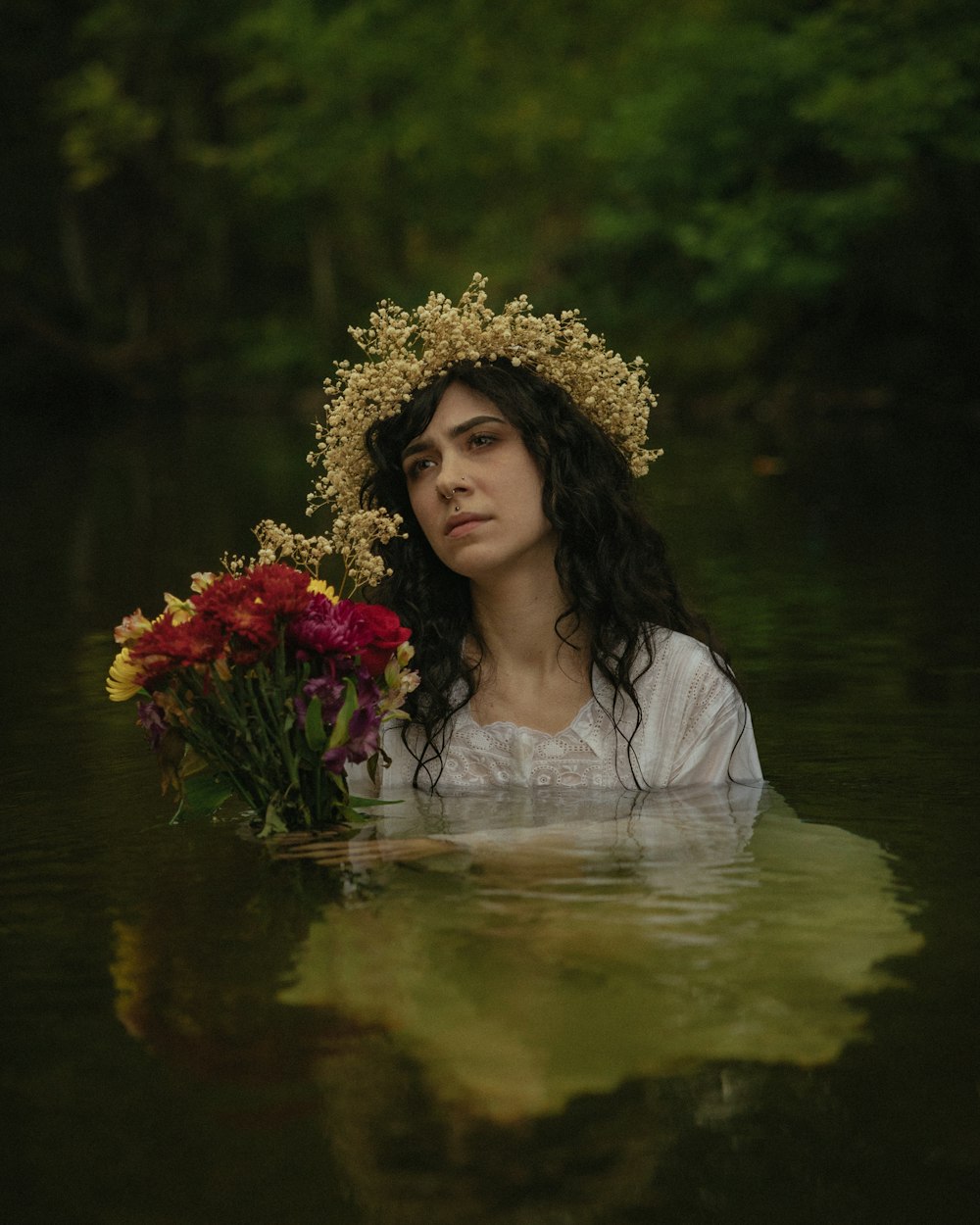 a woman with a wreath on her head holding flowers