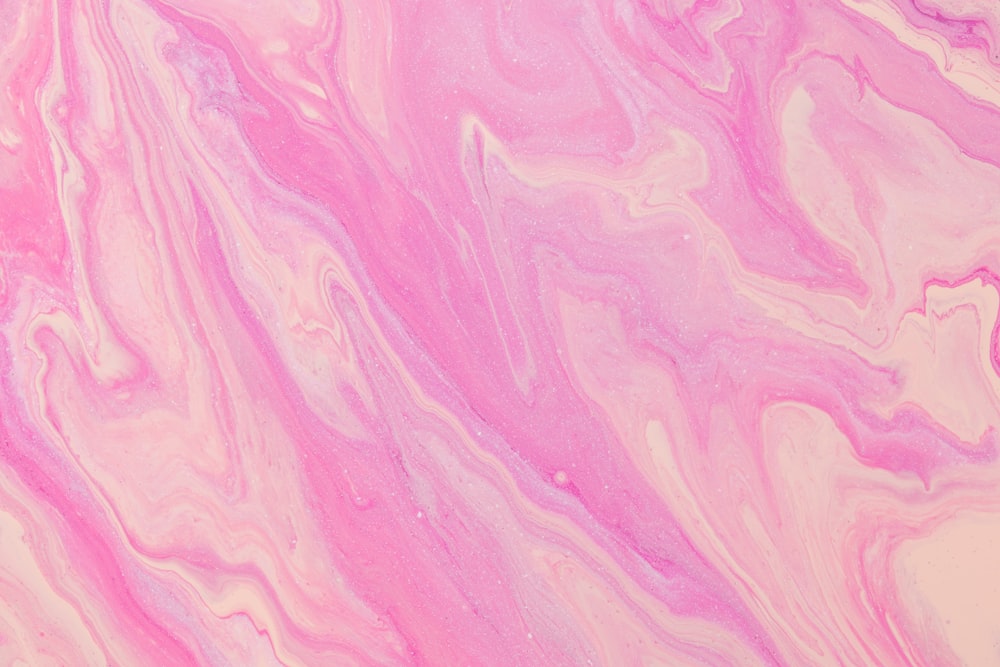 a close up of a pink and white marble