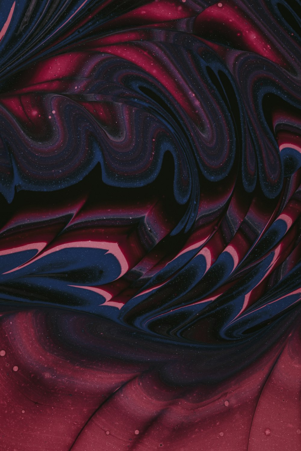 a red and blue background with a swirl pattern