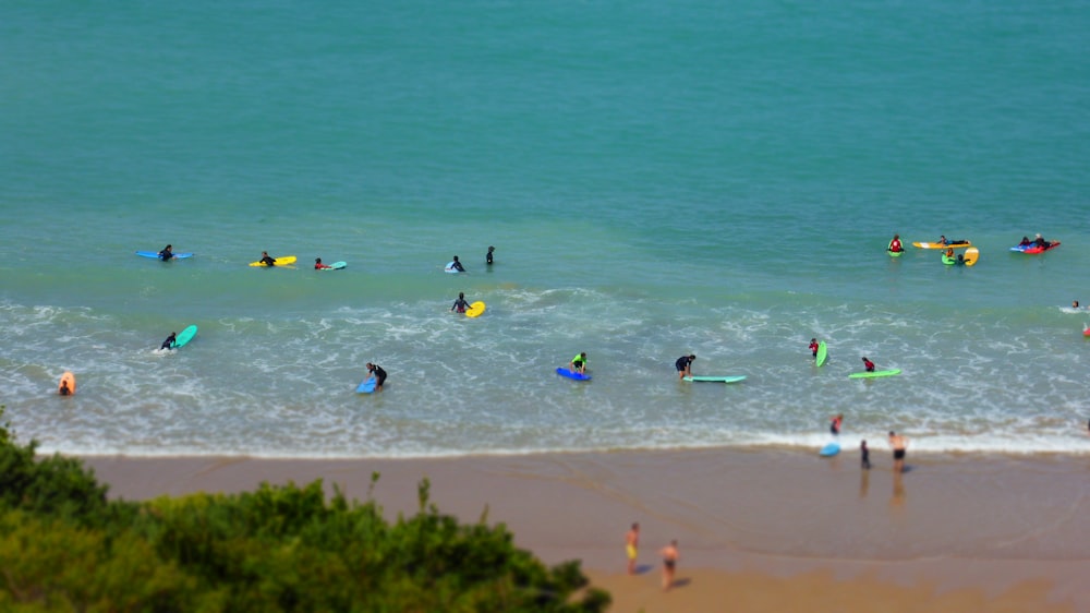 a group of people in the ocean with surfboards