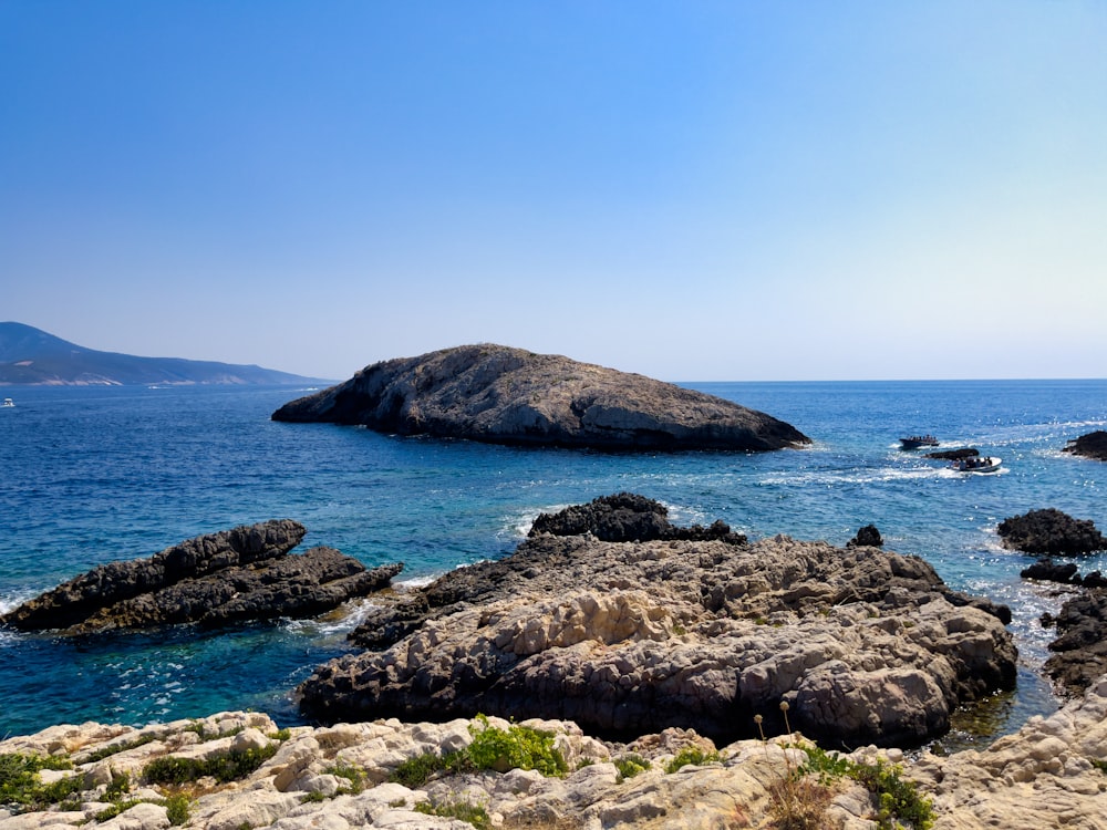 a large rock out in the middle of the ocean