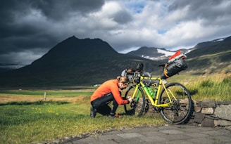 Albert helping a client adjust their bike gear before starting a trail.