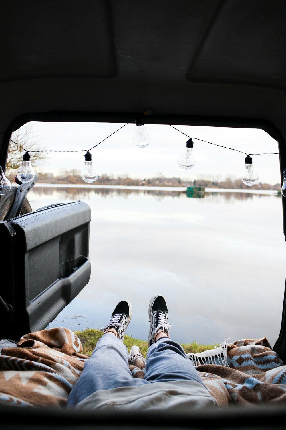 a person laying on a bed in the back of a truck