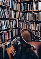 A stylish bookshelf filled with books placed in a relaxing corner.