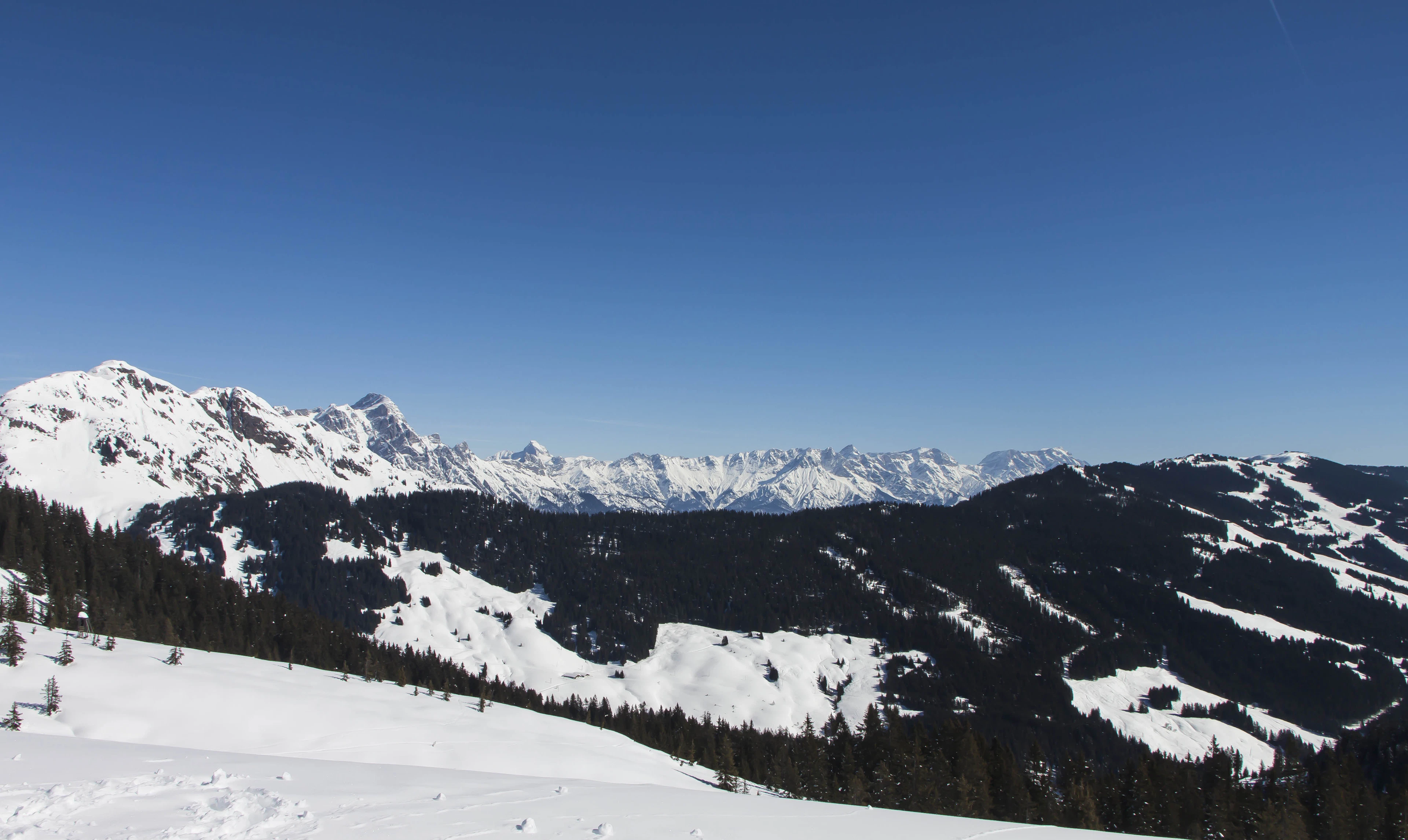 Snowy mountains of the Skicircus seen from a ski slope in Saalbach