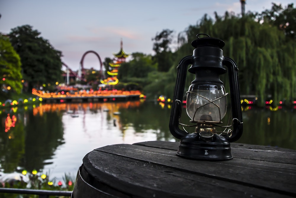 a lantern sitting on top of a wooden table