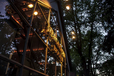 Elegant black and gold-themed image showcasing a luxurious Bangalore apartment exterior at dusk.