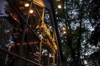 Exterior shot of a building blending harmoniously with its natural surroundings at dusk.