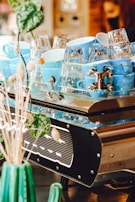 Stacked ceramic cups showcasing a range of blue and green glazes catching soft light.