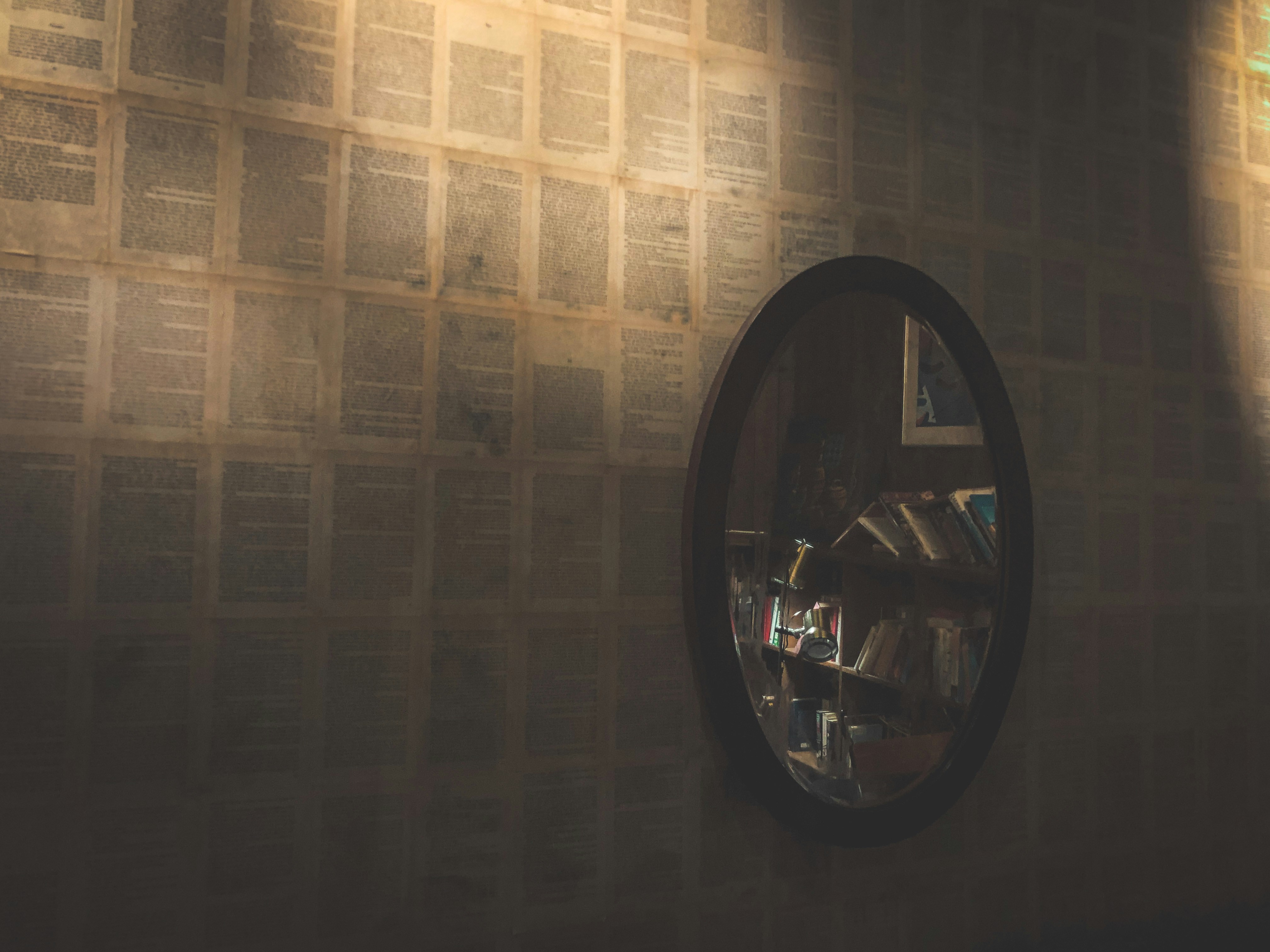 a round mirror on a wall in a room