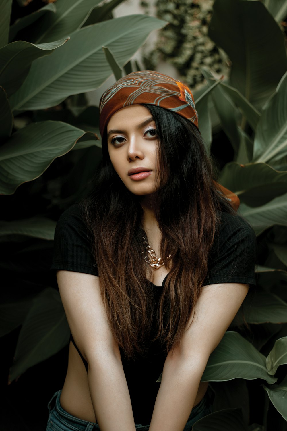 a woman with long hair and a bandana on