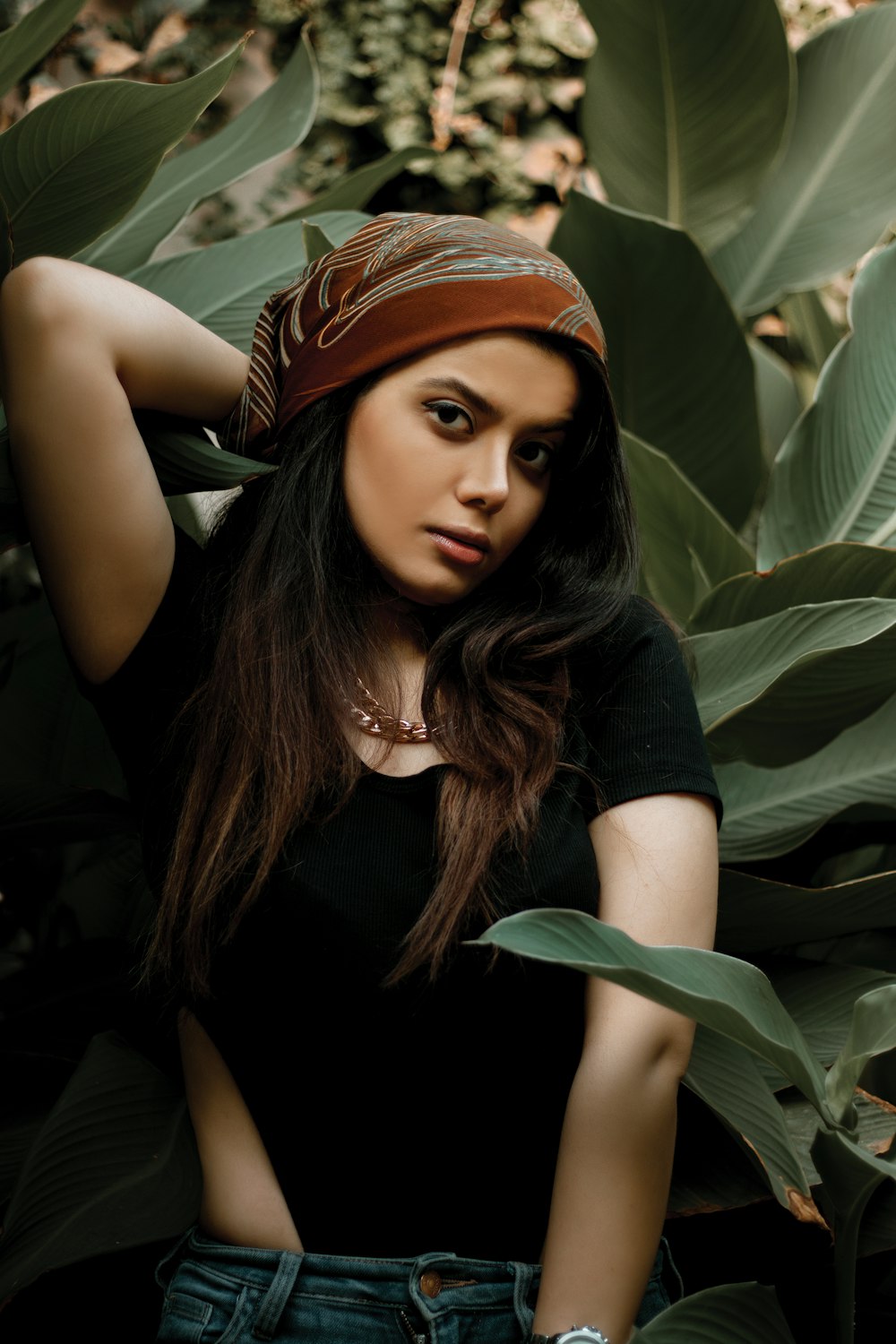 a beautiful young woman wearing a bandana and jeans