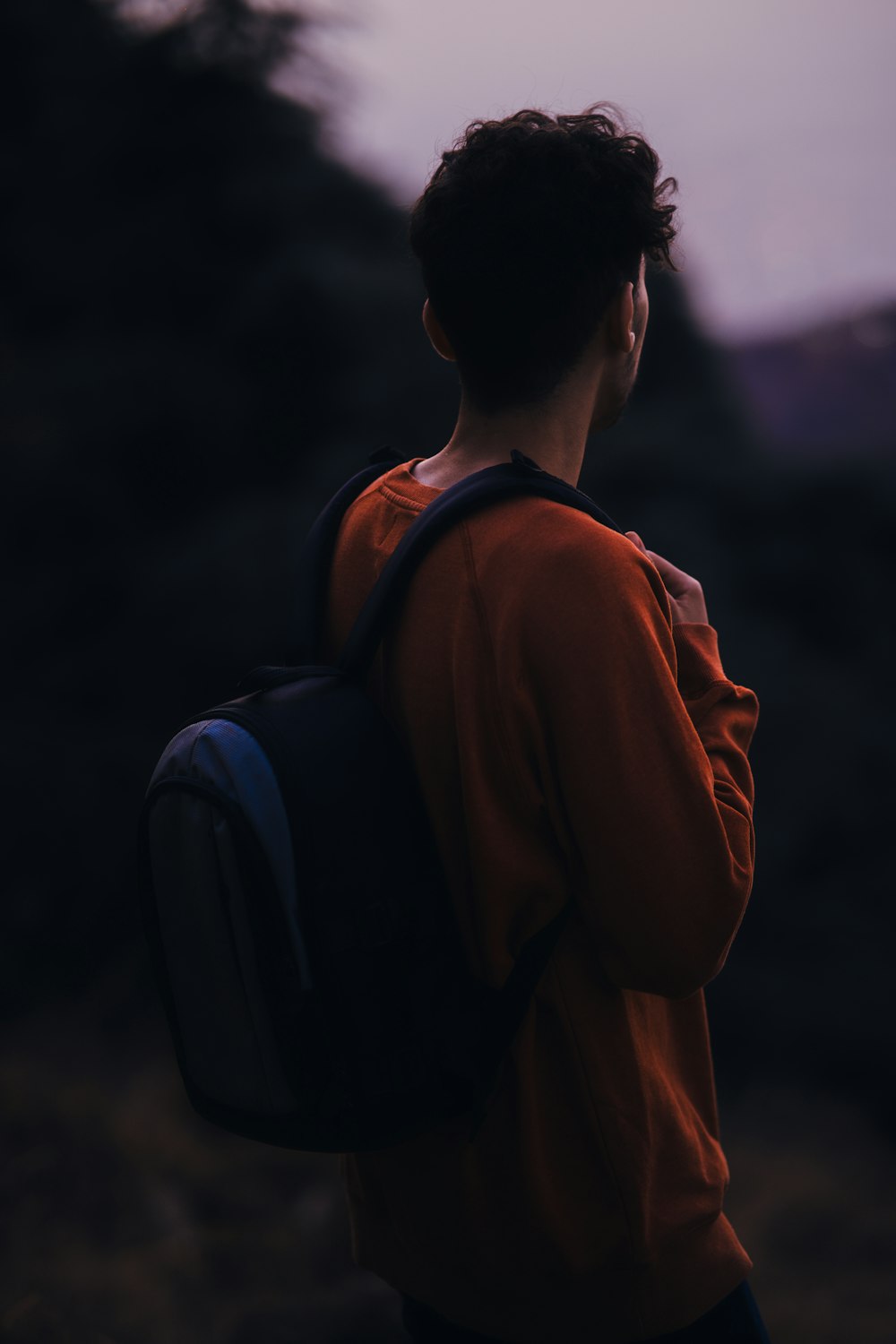 a man with a backpack looking at the sky