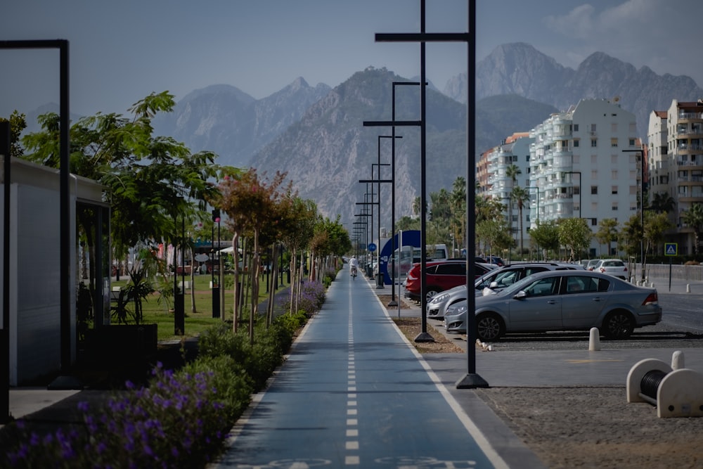 a street lined with parked cars next to tall buildings