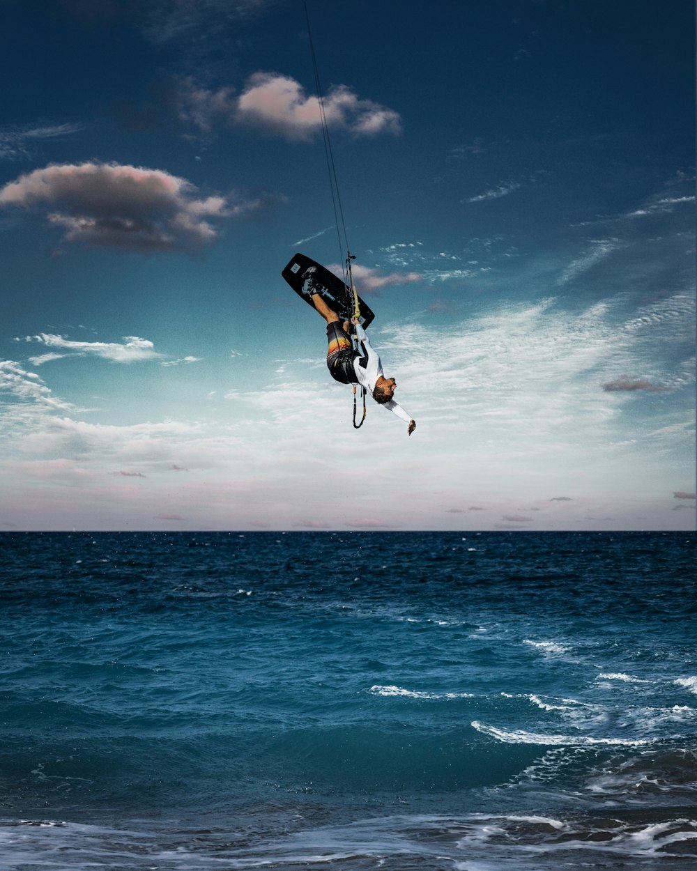 a person on a surfboard in the air over the ocean