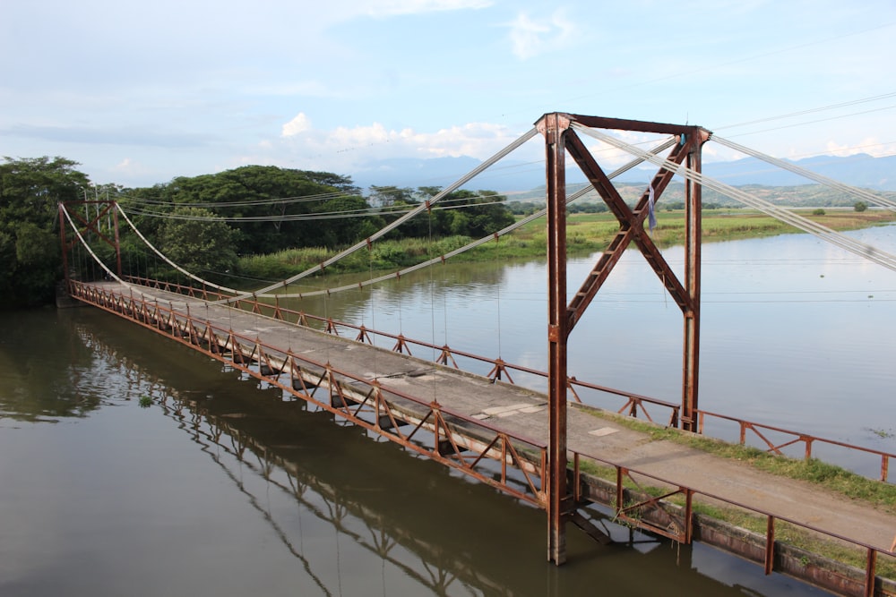 a wooden bridge over a river with a sky background