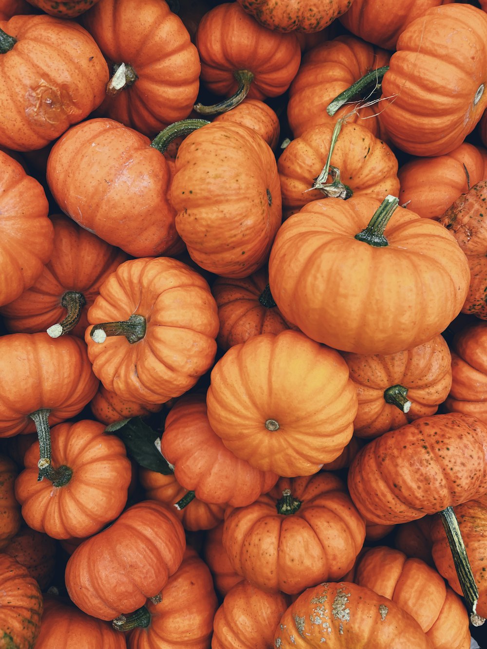 a pile of pumpkins sitting next to each other